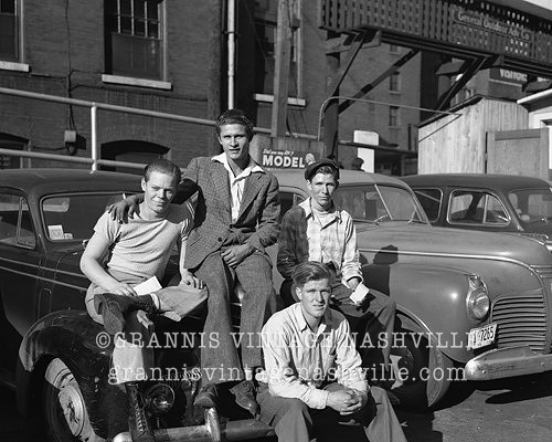 Guys sitting on car